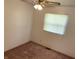 Cozy bedroom with plush carpeting, a ceiling fan, and a window with blinds at 737 Howard St, Shelbyville, IN 46176