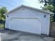 A detached two car garage with a white door and exterior lighting at 737 Howard St, Shelbyville, IN 46176
