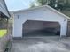 An open two car garage with a workbench and storage at 737 Howard St, Shelbyville, IN 46176