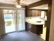 Kitchen and bonus space offers easy transition to outdoor covered space through sliding doors, plentiful cabinets, and bright countertops at 737 Howard St, Shelbyville, IN 46176