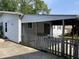 A view of the covered patio featuring a porch swing and a glimpse of the backyard, ideal for relaxing at 737 Howard St, Shelbyville, IN 46176