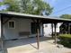 Covered patio with concrete floor and charming porch swings, perfect for outdoor relaxation and entertaining at 737 Howard St, Shelbyville, IN 46176
