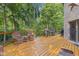 Expansive back deck with patio furniture, grill, and tree-lined backyard at 7612 Freedom Woods Dr, Indianapolis, IN 46259