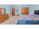 Spacious bedroom featuring a comfortable bed, wooden dresser, and closet with natural light at 7612 Freedom Woods Dr, Indianapolis, IN 46259