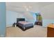 Bright bedroom with a ceiling fan, a comfortable bed, and a wooden desk near the window at 7612 Freedom Woods Dr, Indianapolis, IN 46259