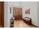 Inviting foyer featuring hardwood floors, wooden bench, decorative mirror and wooden front door at 7612 Freedom Woods Dr, Indianapolis, IN 46259