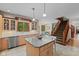 Charming kitchen features granite island, stainless appliances, and view of the staircase at 7612 Freedom Woods Dr, Indianapolis, IN 46259