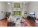 Bright living room with soaring ceilings, large windows, hardwood floors, and comfortable seating at 7612 Freedom Woods Dr, Indianapolis, IN 46259
