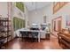 Open-concept living room with fireplace, high ceilings, hardwood floors, and backyard views at 7612 Freedom Woods Dr, Indianapolis, IN 46259