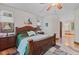 Bright main bedroom offers a ceiling fan, wood floors, and a private ensuite bathroom at 7612 Freedom Woods Dr, Indianapolis, IN 46259