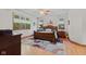 Inviting main bedroom features a plush bed, ceiling fan, and large windows with backyard views at 7612 Freedom Woods Dr, Indianapolis, IN 46259