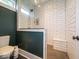 Modern bathroom featuring tiled walls, a glass-enclosed shower, and sleek fixtures at 7728 W 200 S, New Palestine, IN 46163