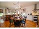 Cozy dining area with wooden table, elegant chandelier, and seamlessly connected to the kitchen at 7728 W 200 S, New Palestine, IN 46163
