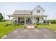 Charming home featuring a large front porch, lush landscaping, and well-maintained lawn at 7728 W 200 S, New Palestine, IN 46163