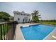 A beautiful backyard oasis with a sparkling in-ground swimming pool and ample seating area at 7728 W 200 S, New Palestine, IN 46163