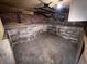 Basement with concrete floor and brick walls at 807 N Elm St, Muncie, IN 47305