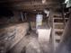 Unfinished basement with exposed brick, wood beams, and water heater at 807 N Elm St, Muncie, IN 47305
