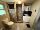 Bathroom with a shower stall, tiled walls, and a single sink vanity at 807 N Elm St, Muncie, IN 47305