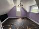 Attic bedroom with slanted ceilings, overhead lighting, and two windows at 807 N Elm St, Muncie, IN 47305
