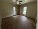 A spacious bedroom featuring hardwood floors and natural light from two large windows at 807 N Elm St, Muncie, IN 47305