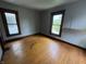 Empty bedroom with hardwood floors and two windows for natural light at 807 N Elm St, Muncie, IN 47305