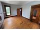 Spacious bedroom featuring wood floors, natural light from the window, and wood trim at 807 N Elm St, Muncie, IN 47305