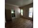 Empty bedroom with wood floors and view of the bathroom through the doorway at 807 N Elm St, Muncie, IN 47305