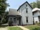 A charming, two-story home with a covered entryway and a well-manicured front lawn at 807 N Elm St, Muncie, IN 47305