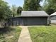 A detached garage with both sliding and swing out doors, surrounded by a grassy yard at 807 N Elm St, Muncie, IN 47305