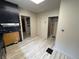 Bright kitchen with light wood floors, black cabinets, and decorative marble backsplash at 807 N Elm St, Muncie, IN 47305
