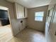Small laundry room area with overhead cabinets and linoleum tiled flooring at 807 N Elm St, Muncie, IN 47305