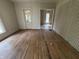 A living room with hardwood floors and an adjacent sunroom view at 807 N Elm St, Muncie, IN 47305
