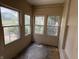 A sunroom enclosed with multiple windows offering natural light and views of the outdoors at 807 N Elm St, Muncie, IN 47305