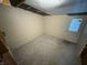 Room features damaged drywall, carpeted flooring, and a back door at 807 N Elm St, Muncie, IN 47305