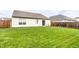 Lush backyard with well-maintained lawn, privacy fence, and a view of neighboring houses at 8116 Harshaw Dr, Indianapolis, IN 46239