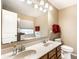 Bathroom with double vanity, large mirror, and separate tub/shower at 8116 Harshaw Dr, Indianapolis, IN 46239