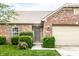 Charming front exterior with brick facade, manicured bushes, and a well-lit entryway at 8116 Harshaw Dr, Indianapolis, IN 46239