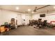 Large garage featuring a storage area with various items and a rubber floor at 8116 Harshaw Dr, Indianapolis, IN 46239