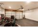 Spacious garage with rubber flooring, an overhead door, and ample space for a workout area at 8116 Harshaw Dr, Indianapolis, IN 46239