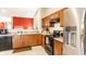 Spacious kitchen with stainless steel refrigerator, wooden cabinets, and tile flooring at 8116 Harshaw Dr, Indianapolis, IN 46239
