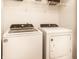 Neat laundry area showcasing a Whirlpool washer and dryer, along with wire shelving for storage at 8116 Harshaw Dr, Indianapolis, IN 46239