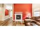 Cozy living room with a fireplace, hardwood floors, and comfortable seating creating an inviting atmosphere at 8116 Harshaw Dr, Indianapolis, IN 46239