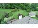A backyard featuring a lush green lawn, mature trees, privacy fence, a fire pit, and a storage shed at 8144 Grassy Meadow Cir, Indianapolis, IN 46259
