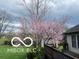 A flowering tree stands in a fenced backyard near the back of a home at 8144 Grassy Meadow Cir, Indianapolis, IN 46259