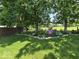 A verdant backyard with expertly designed landscaping and a stone border at 8144 Grassy Meadow Cir, Indianapolis, IN 46259