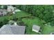 Expansive backyard featuring lush green lawn, mature trees, privacy fence, a fire pit, and a storage shed at 8144 Grassy Meadow Cir, Indianapolis, IN 46259
