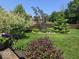 This manicured backyard features an expertly designed landscape with colorful flowering plants at 8144 Grassy Meadow Cir, Indianapolis, IN 46259
