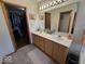Bathroom features dual sinks, framed mirror, and access to walk-in closet at 8144 Grassy Meadow Cir, Indianapolis, IN 46259