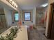 Well-lit bathroom showcases a dual sink vanity, large mirrors, and a soaking tub at 8144 Grassy Meadow Cir, Indianapolis, IN 46259