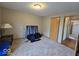 This bedroom features neutral carpet, tan walls, and a light fixture at 8144 Grassy Meadow Cir, Indianapolis, IN 46259